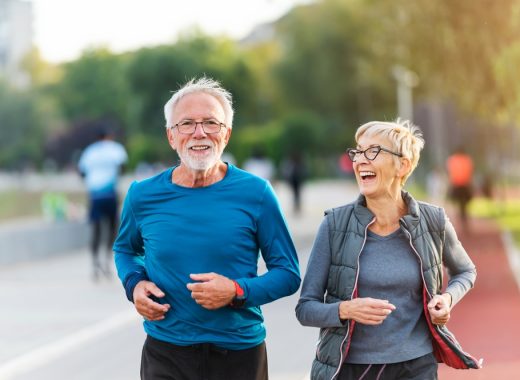 Cheerful,Active,Senior,Couple,Jogging,Together,Outdoors,Along,The,River.
